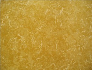 I'm a cream feather over a mottled orange-brown background.